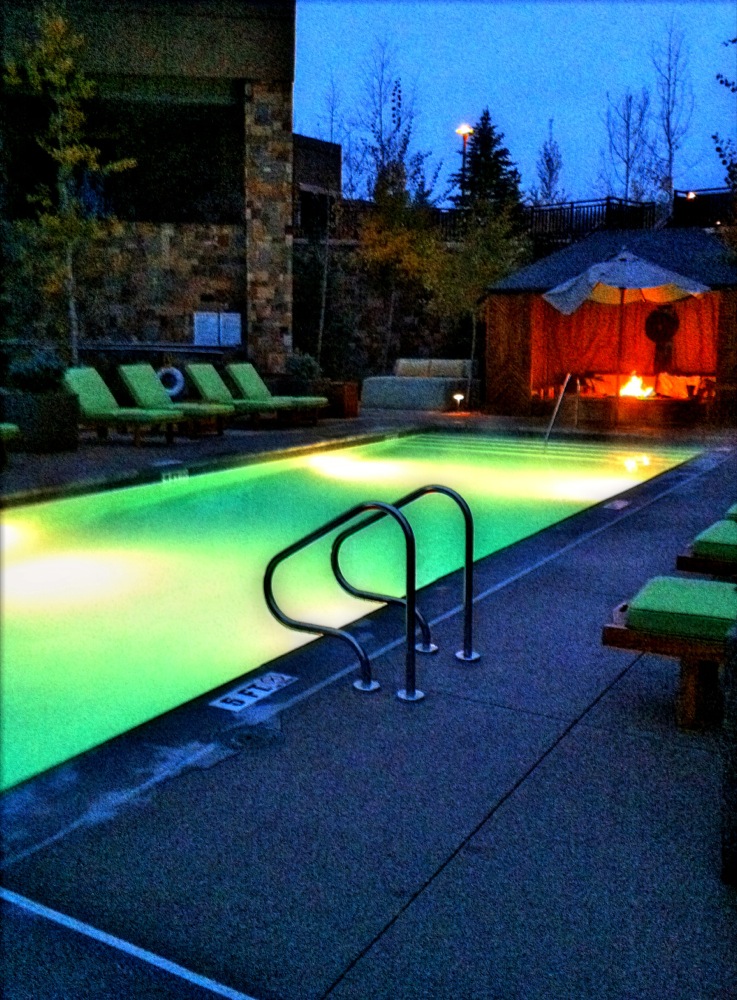 Fireplaces are situated at both ends of the outdoor pool, which also boasts mountain views. 