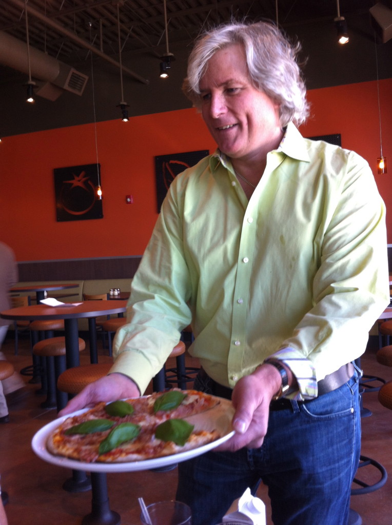 Tom Ryan, creator of Smashburger and Tom's Urban 24 showcases a creation from his newest concept, Live Basil Pizza. "The idea behind this is that have a place for people to come get pizza and feel good about eating it," says Ryan.