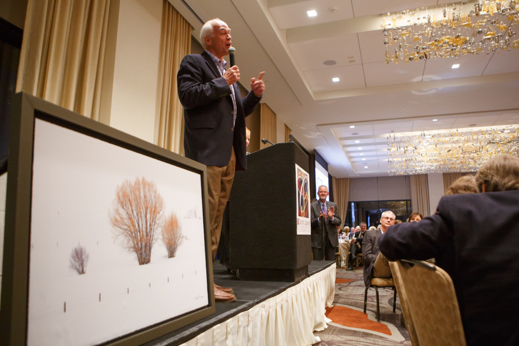 John Fielder introduces his live auction package, including a field class and this giclee photo.  The “9th Annual Shining Lights of Hope” gala, benefiting the Carson J. Spencer Foundation, at the Pinnacle Club, Grand Hyatt Denver, in Denver, Colorado, on Sunday, Aug. 25, 2013. Photo Steve Peterson